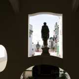Gli edifici di Bari vecchia fanno da sfondo alla statua che si affaccia dal primo piano 